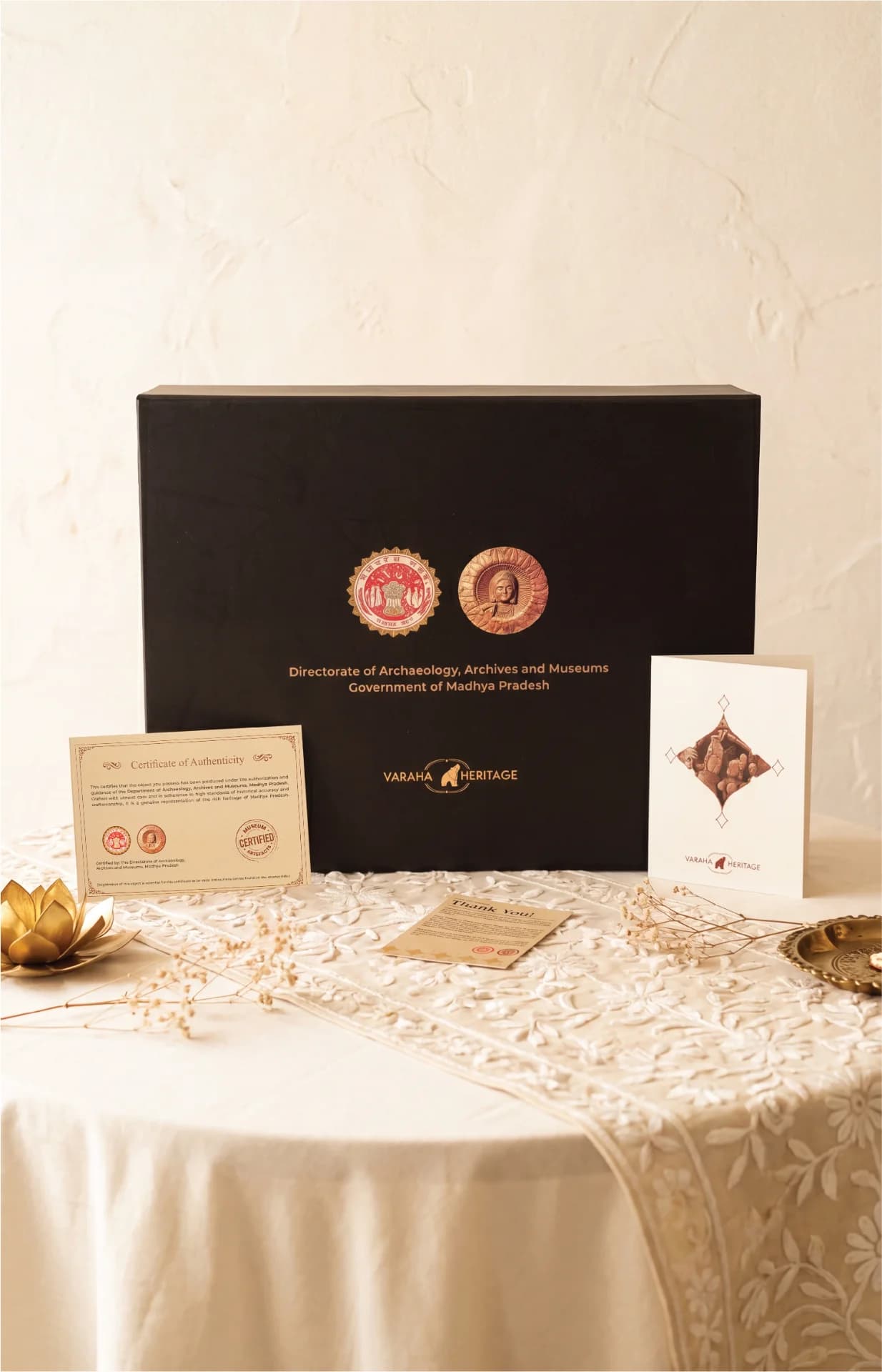 The Lakshmi Narayan Sculpture packaging box displayed with a certificate of authenticity and a branded greeting card.