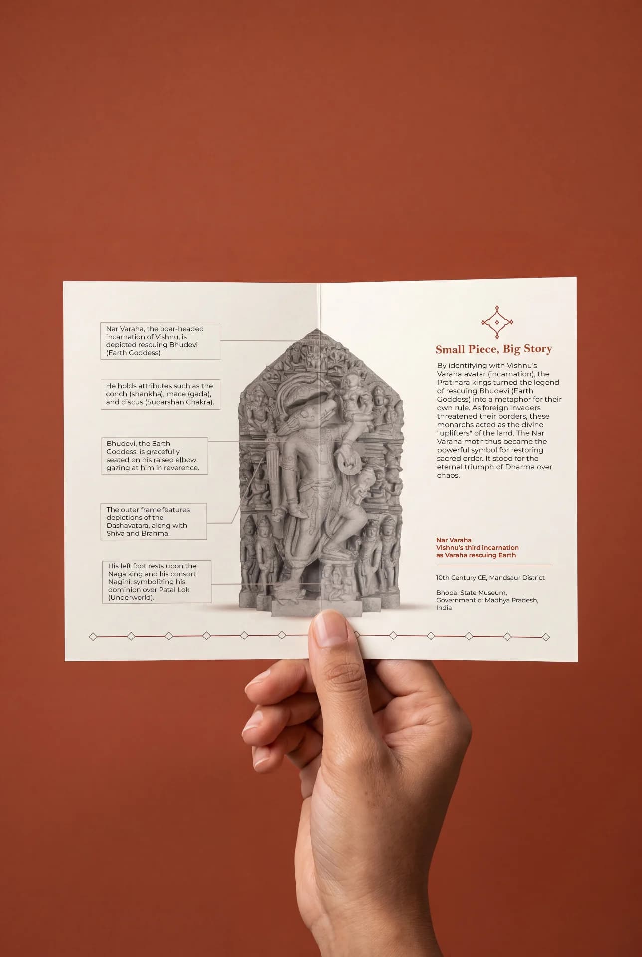 A hand holds an informational card featuring the Nar Varaha Sculpture, showcasing detailed historical annotations about this stone composite replica.