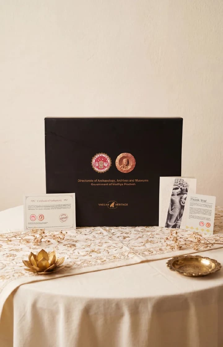 The Nar Varaha Sculpture presentation box with certificate of authenticity and thank you card on a decorated table.