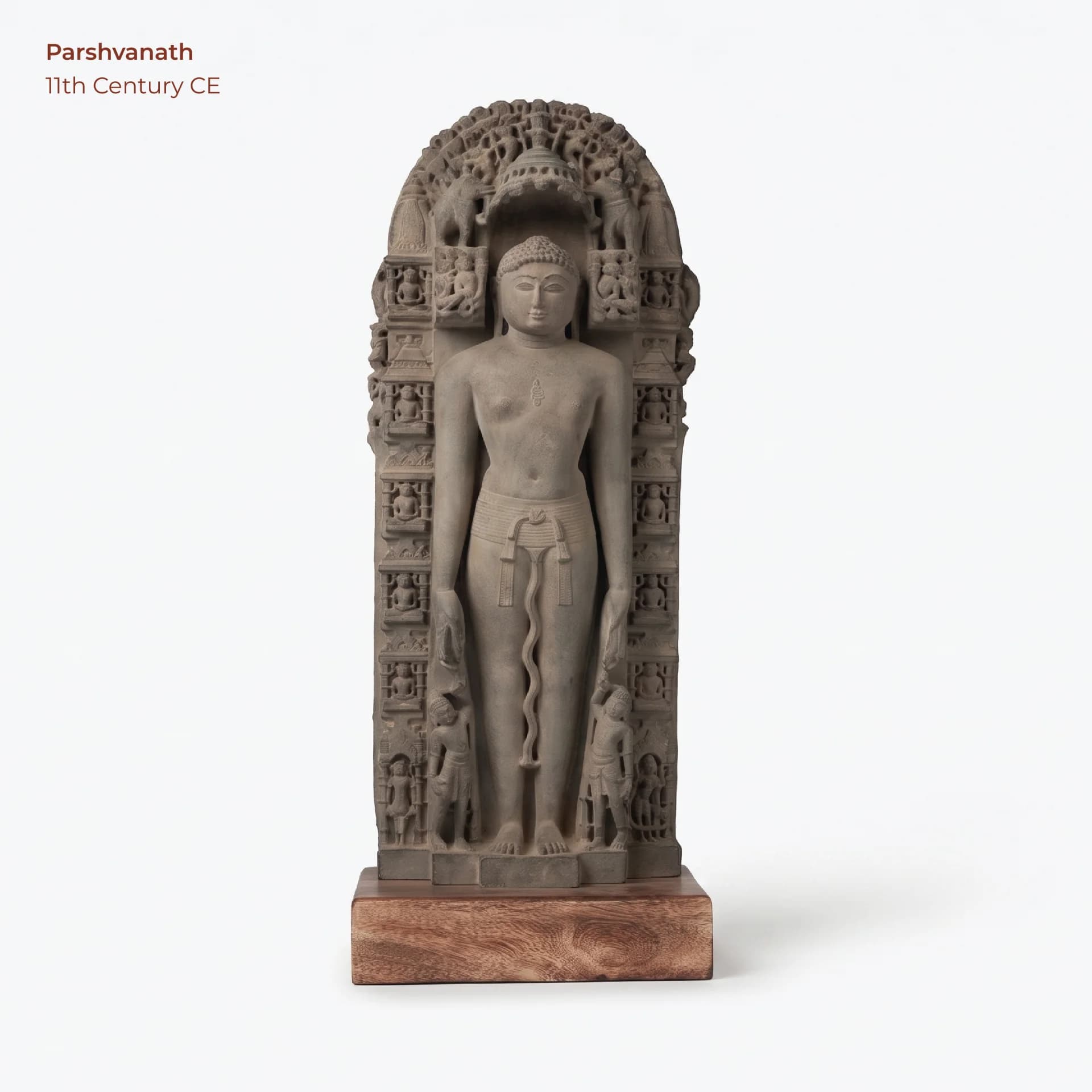 A full-length front view of the Parshvanath Sculpture, a detailed stone-finish museum replica featuring intricate Solanki-era carvings.