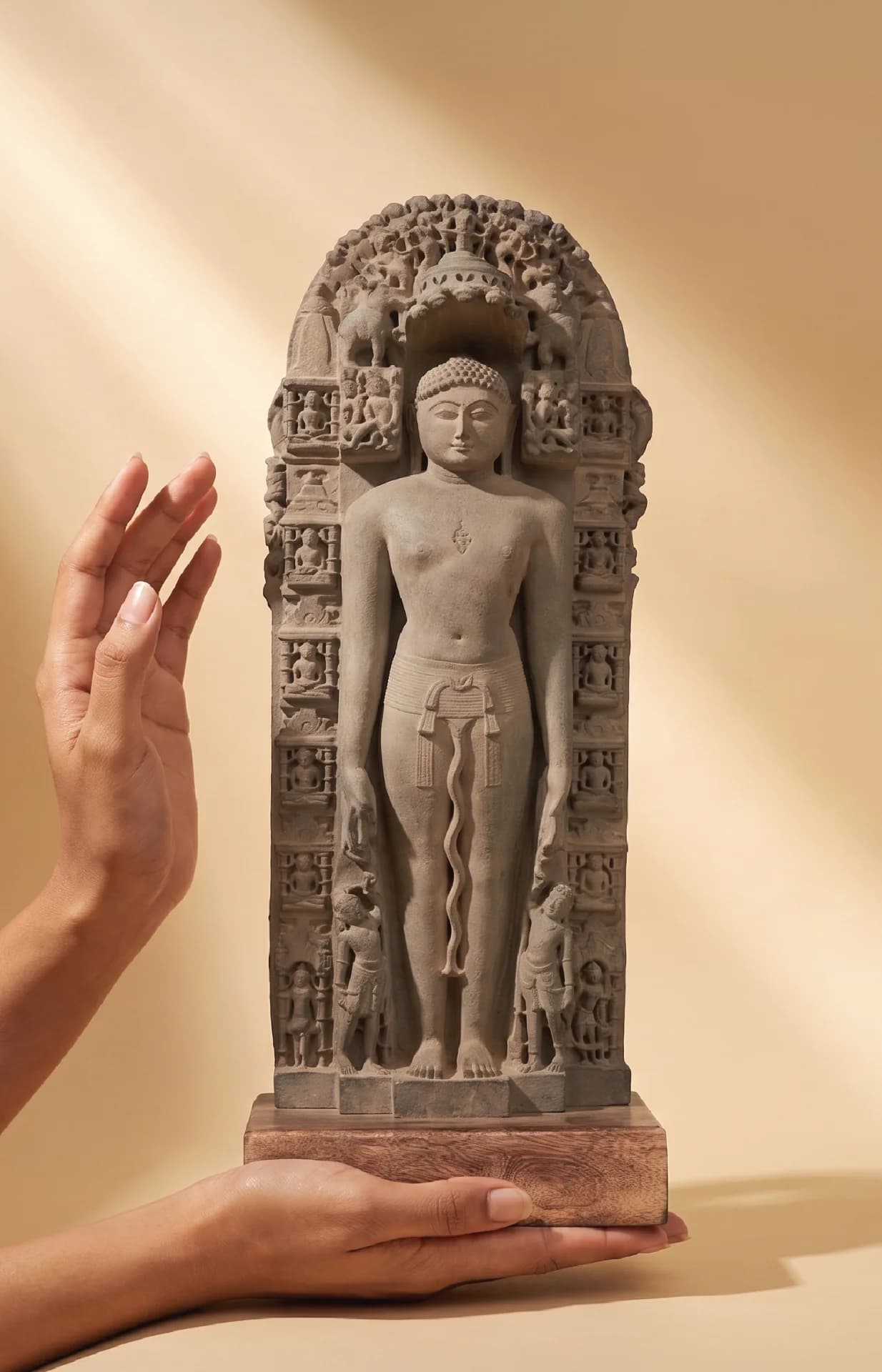 A hand holds a stone composite Parshvanath Sculpture, showcasing the intricate 11th-century Solanki-era Jain Tirthankara museum replica details.
