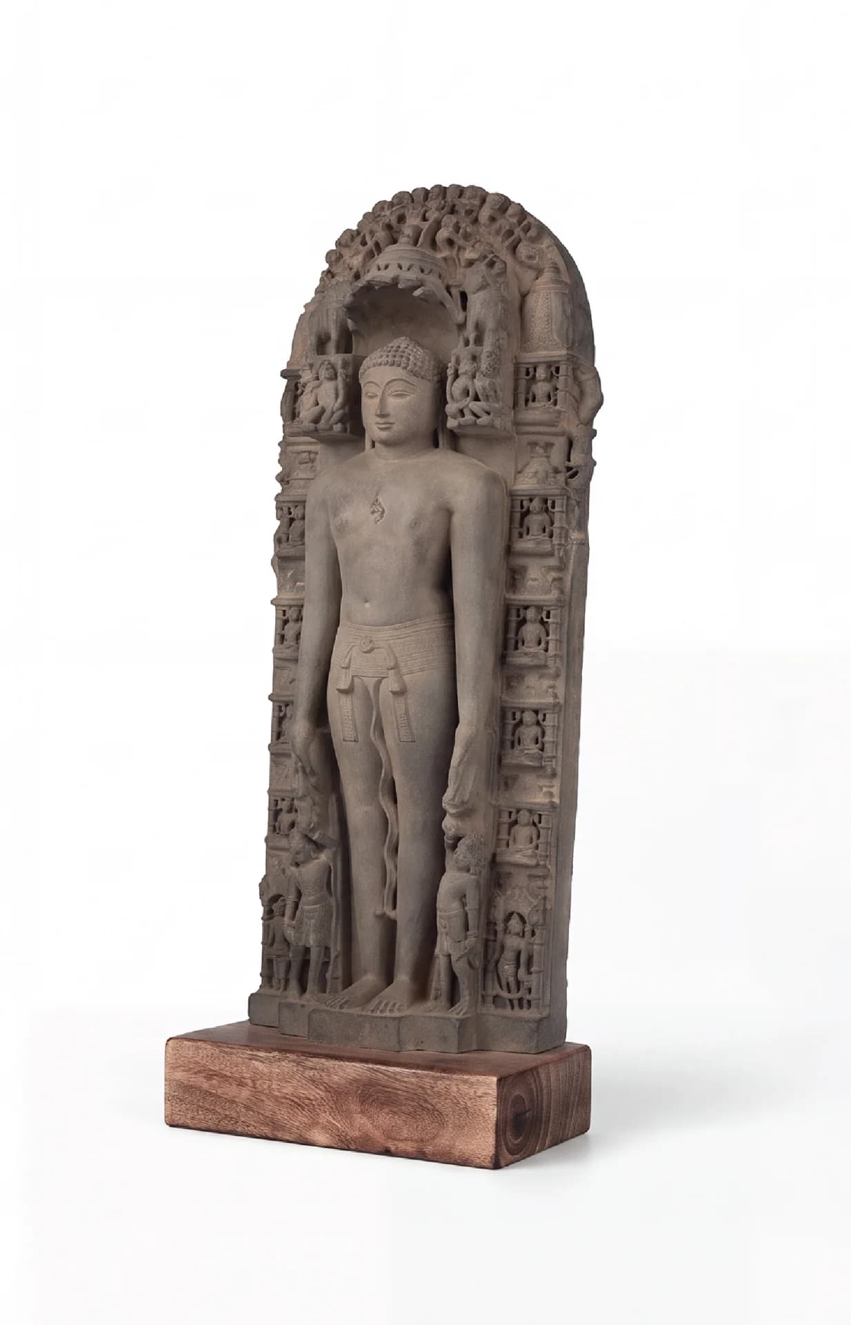 A three-quarter view of the Parshvanath Sculpture, a stone composite replica featuring intricate carvings of a Jain Tirthankara.