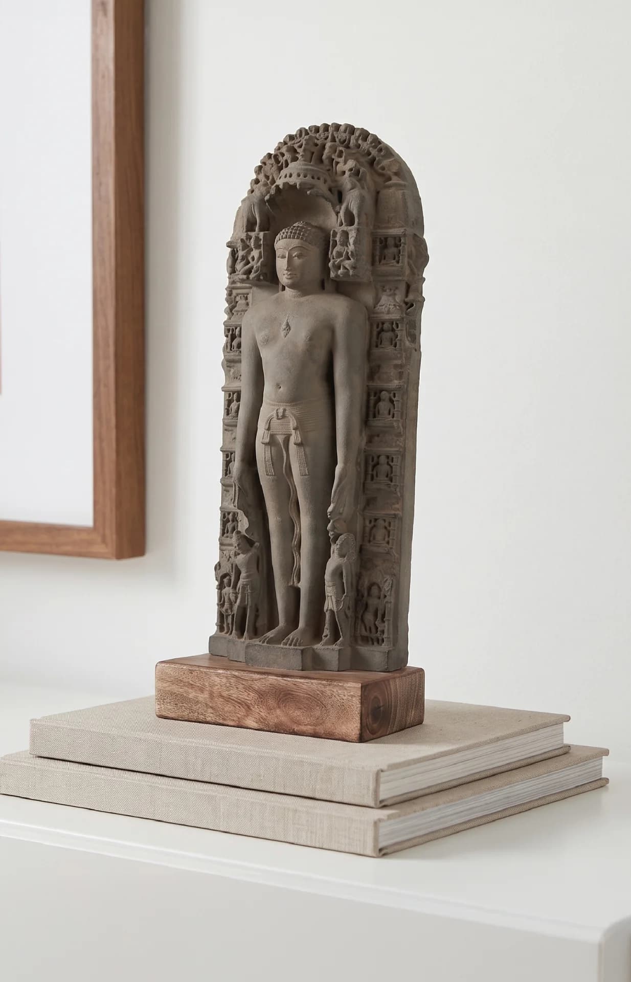 A three-quarter view of the Parshvanath Sculpture, a stone composite replica featuring intricate carvings of the Jain Tirthankara.