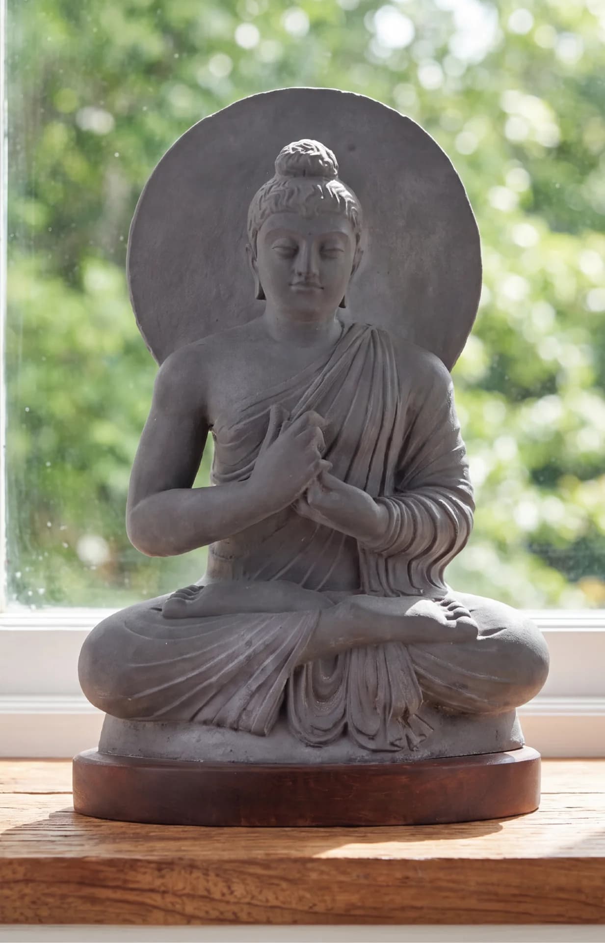A front-facing view of the Preaching Buddha statue, showcasing its detailed stone composite texture and serene Gandhara art style.