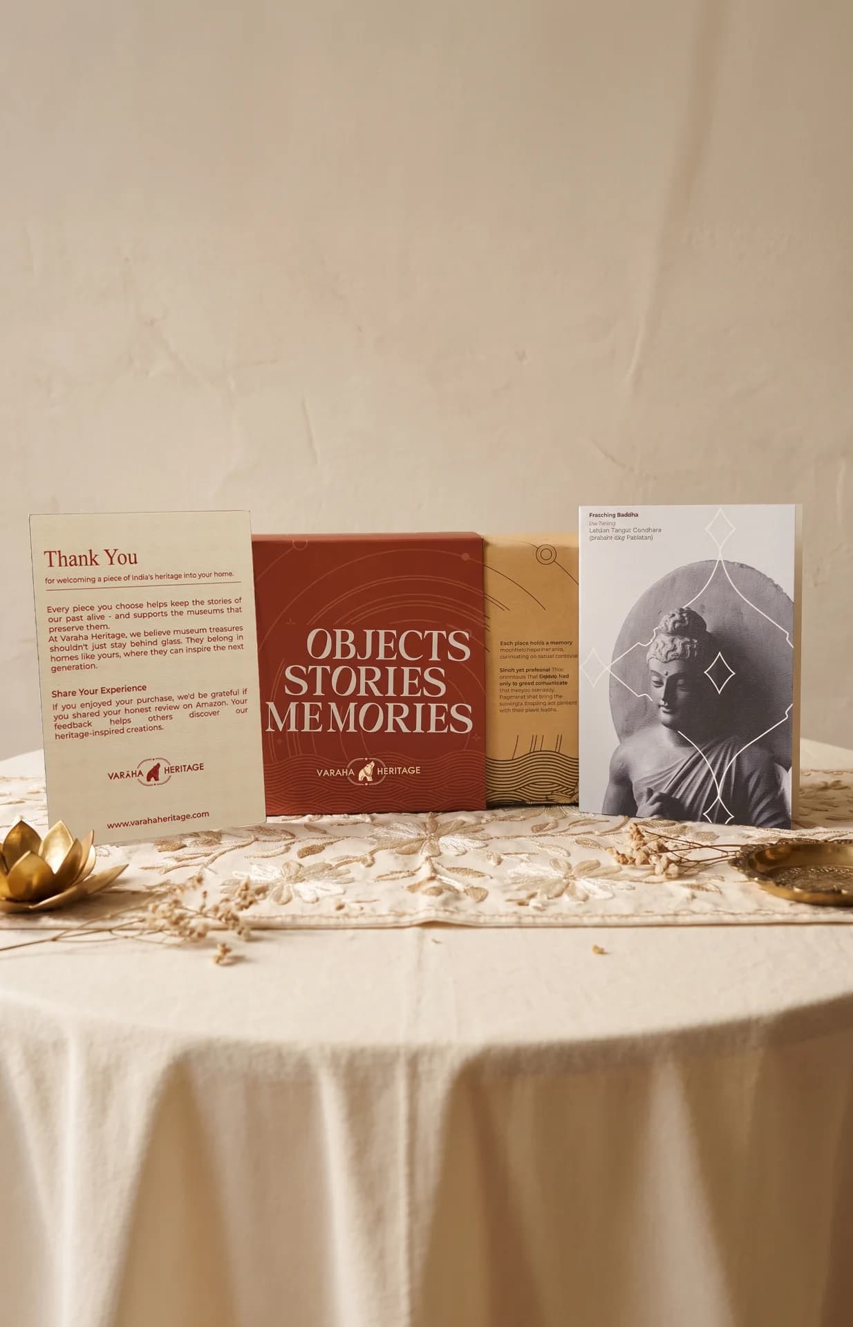 A Preaching Buddha museum replica card displayed alongside branded packaging boxes and a thank you note on a table.
