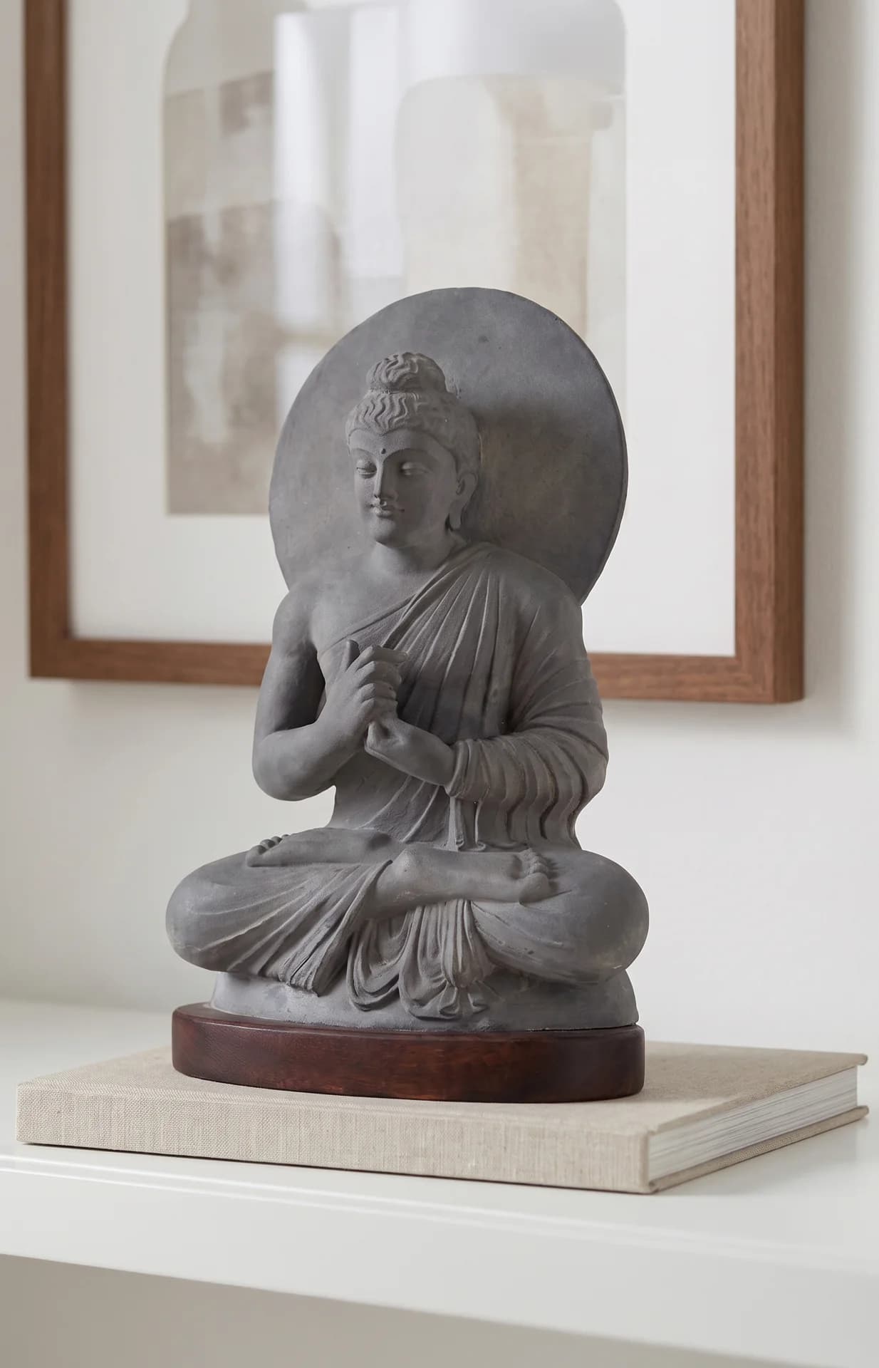 A three-quarter view of the Preaching Buddha statue, featuring a grey stone composite finish and traditional Gandhara art styling.