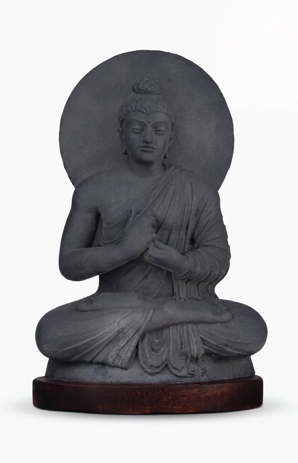 A front-facing view of the Preaching Buddha stone composite statue, seated in a meditative lotus position against a halo.