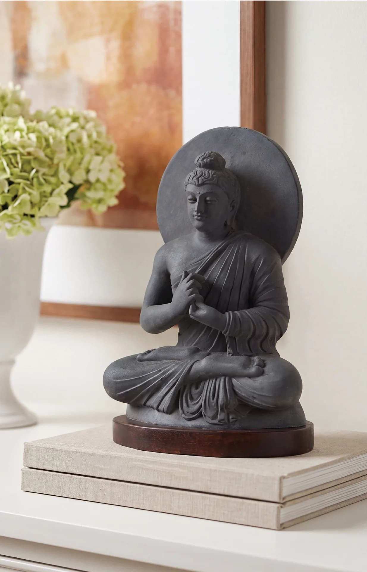 A stone composite Preaching Buddha statue in the Gandhara style, seated in lotus position on a wooden base.