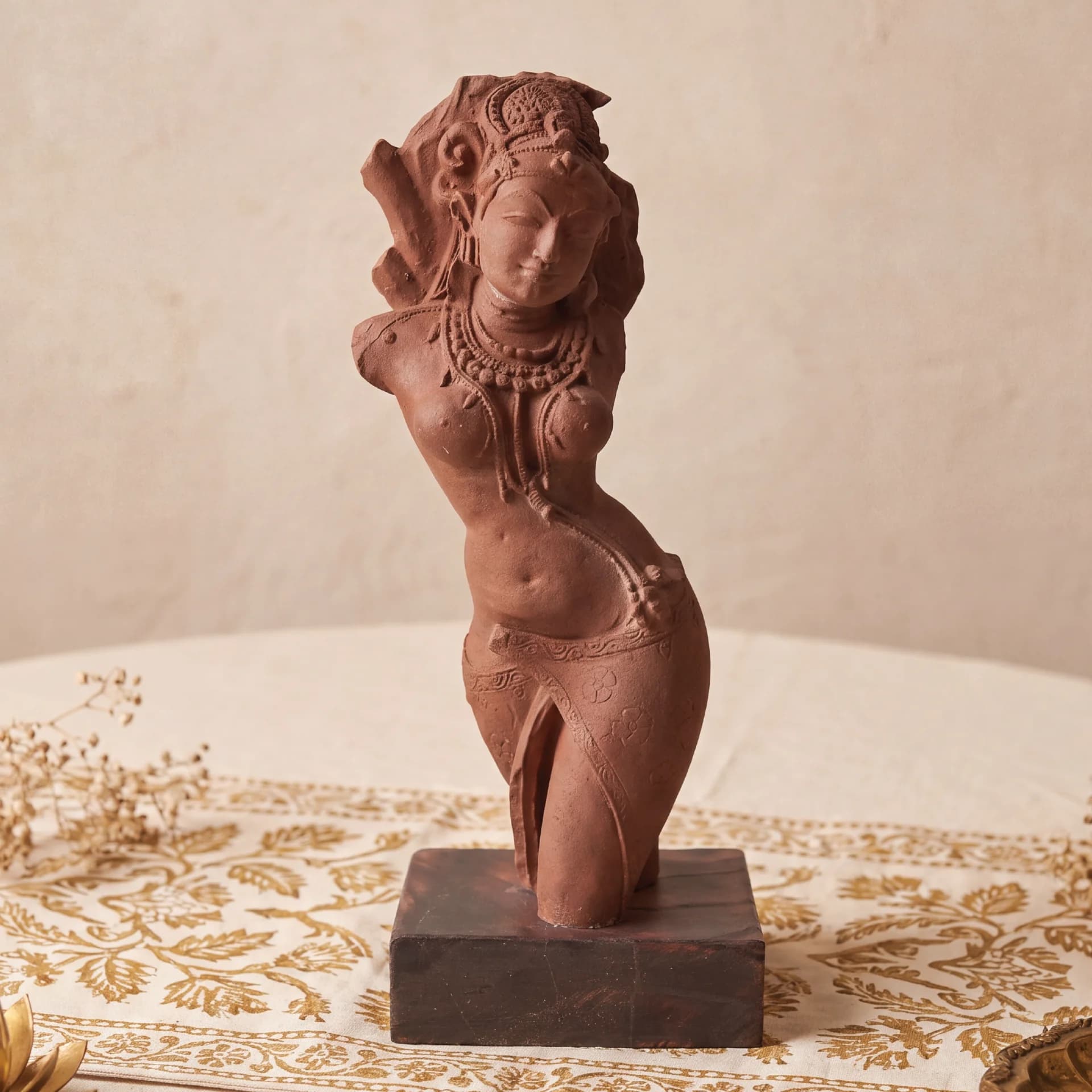A front view of the Salabhanjika Sculpture, a hand-finished stone composite figure standing elegantly on a dark wooden base.
