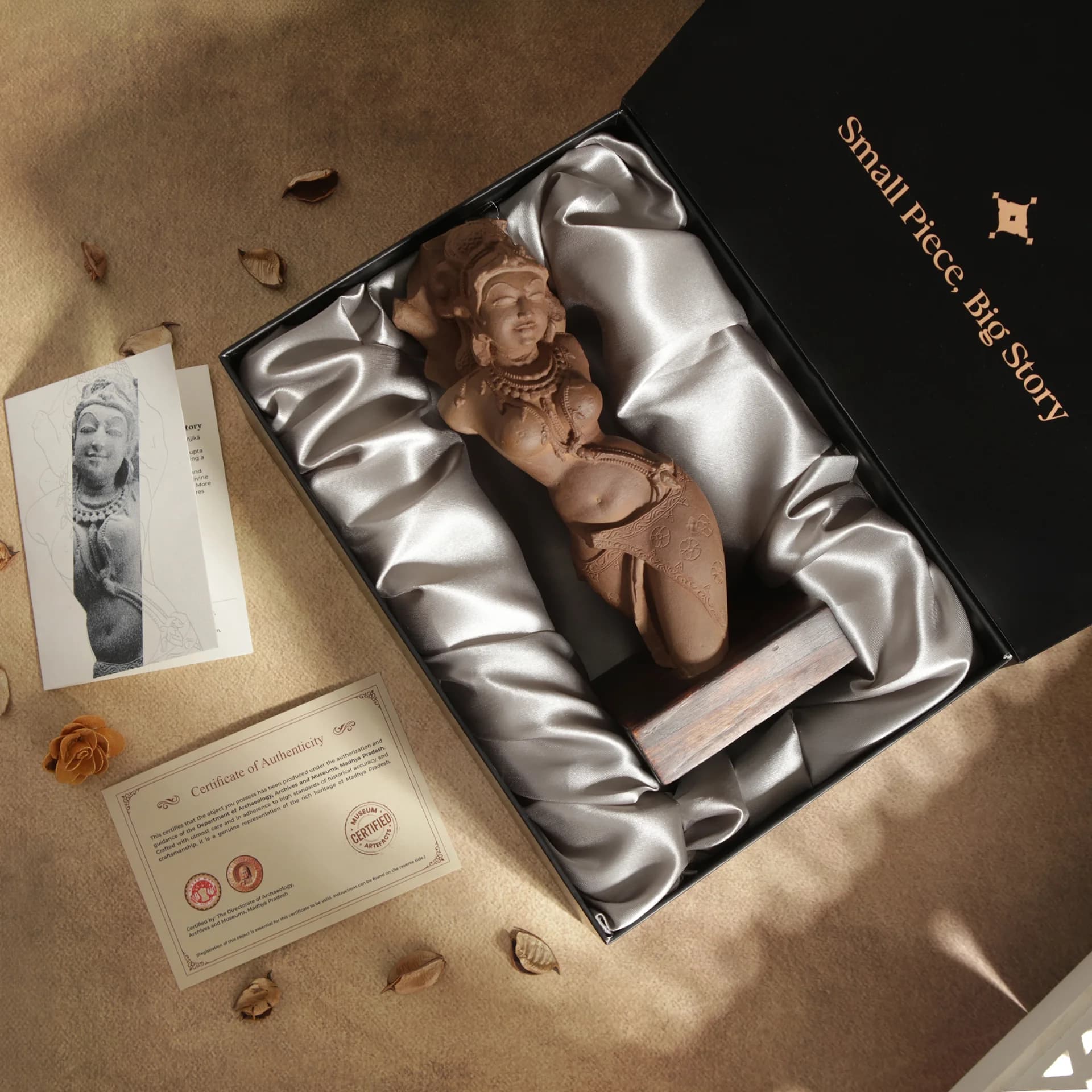 A Salabhanjika Sculpture replica nestled in a silk-lined gift box with an authenticity certificate and informational card.