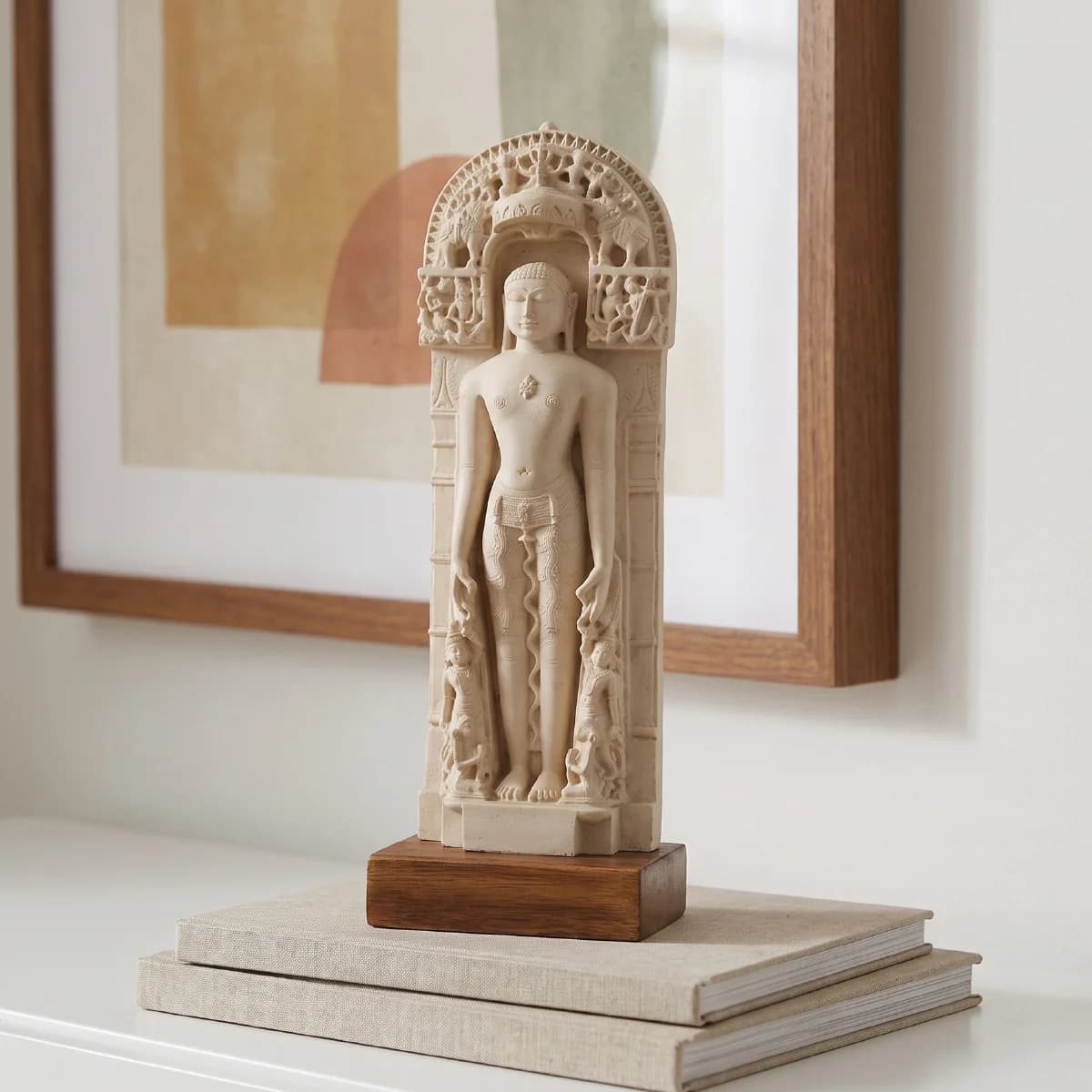 A full front view of the Shantinath Sculpture, a detailed marble-finish museum replica standing on a wooden base.