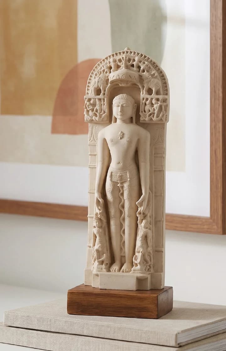 A front view of the Shantinath Sculpture, a detailed marble-style museum replica featuring an intricate arched niche and canopy.