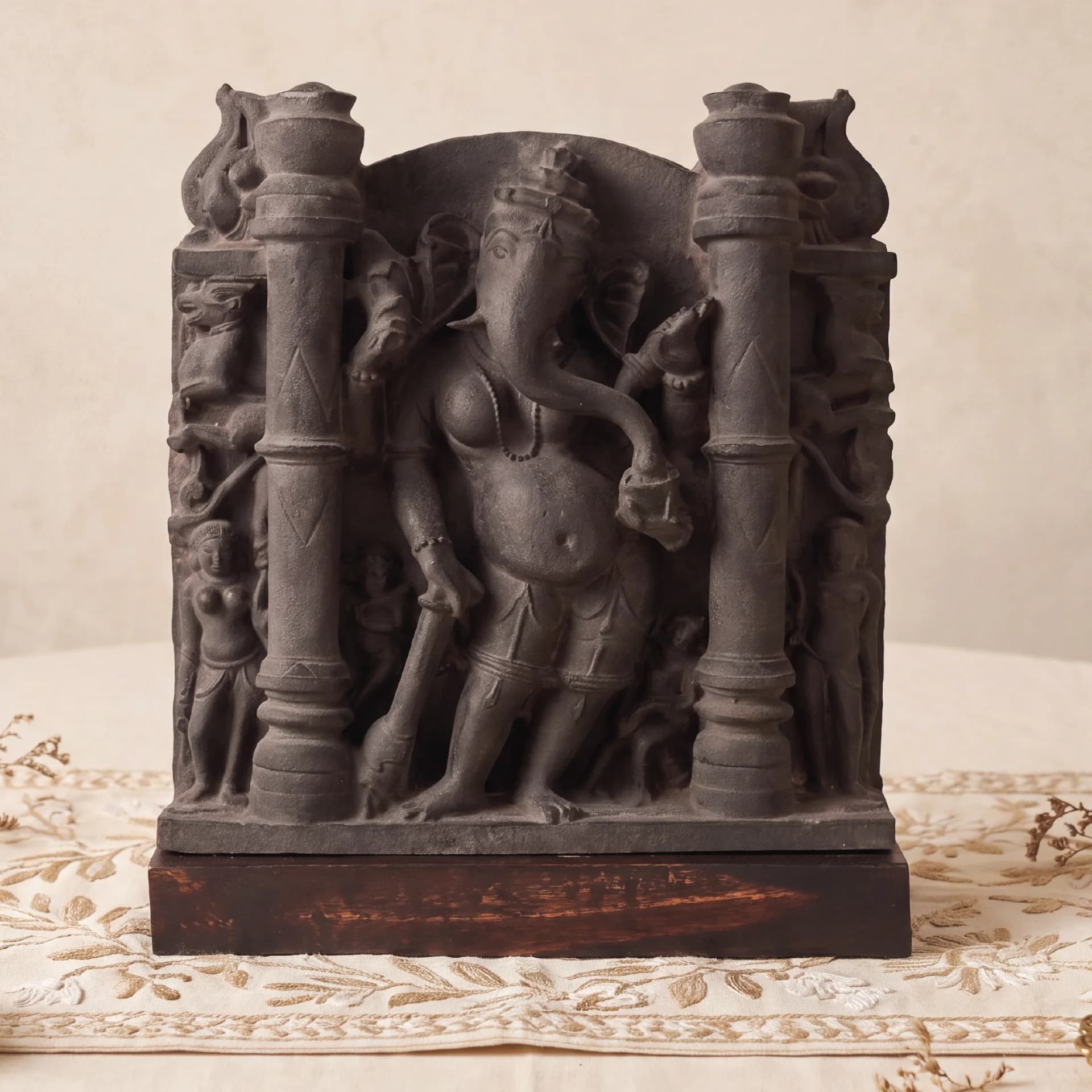 A front view of the Vinayaki Sculpture, a dark stone museum replica featuring intricate medieval Indian temple iconography.