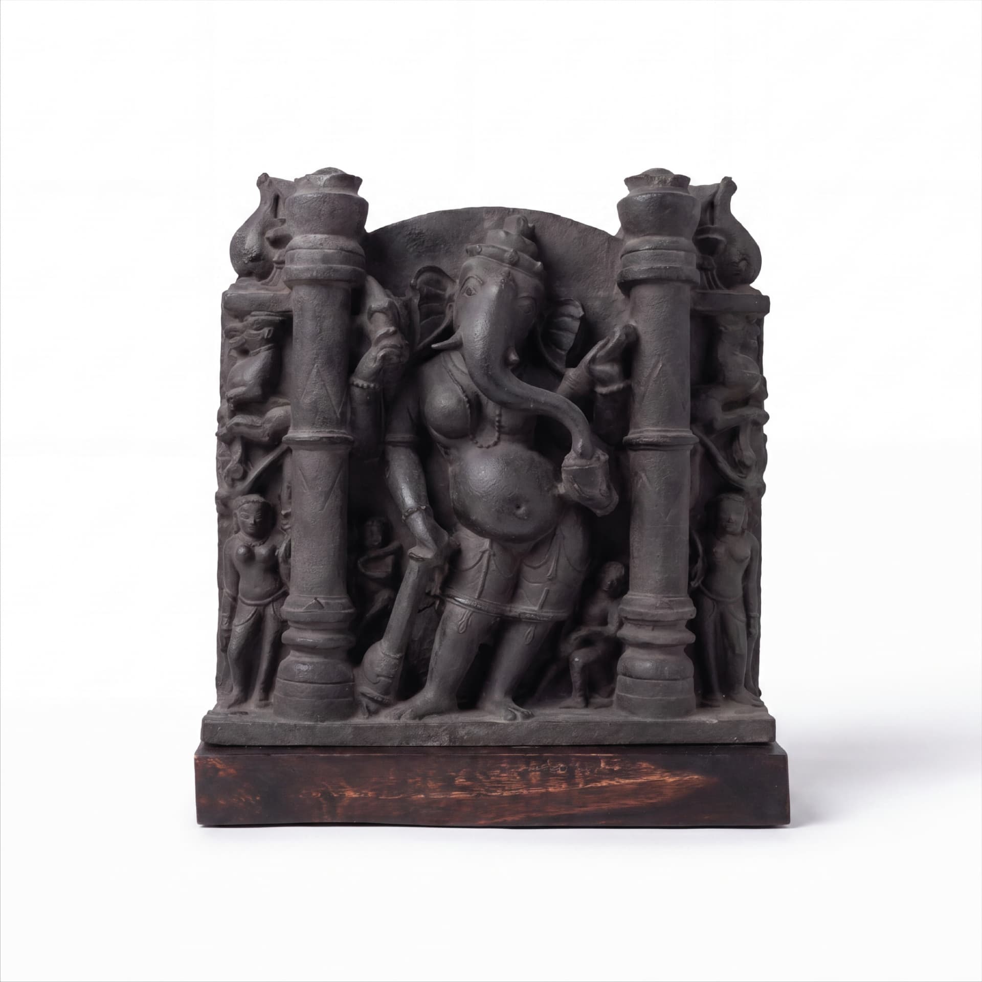 A museum-grade Vinayaki Sculpture replica featuring intricate dark stone carving of the elephant-headed deity standing between two pillars.