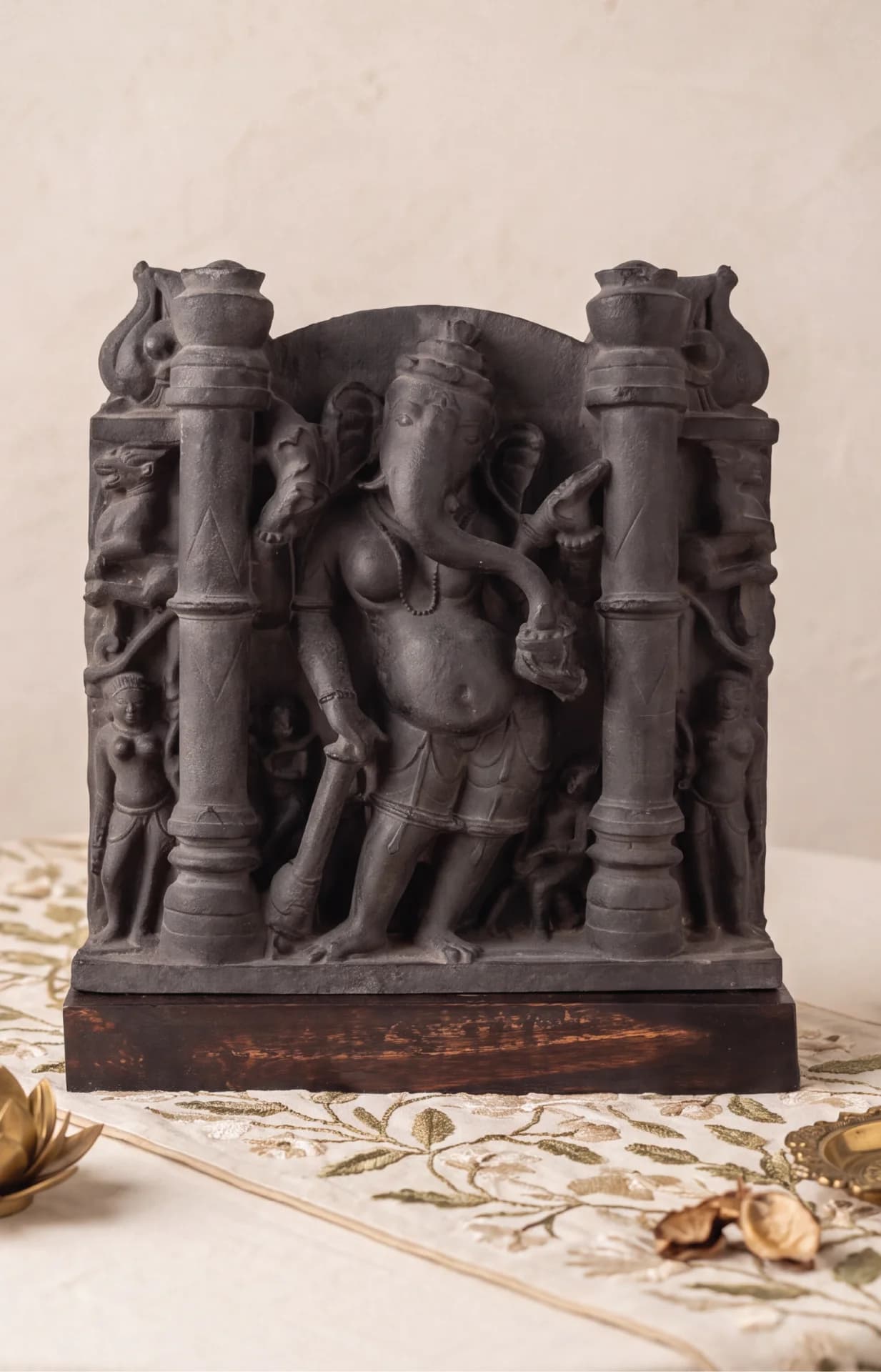 A front-facing view of the Vinayaki Sculpture, a dark stone museum replica featuring intricate 11th-century medieval Indian iconography.